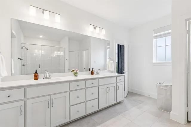 a bathroom with double sink and a mirror
