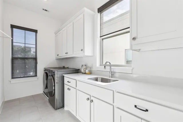 a kitchen with a sink cabinets and window