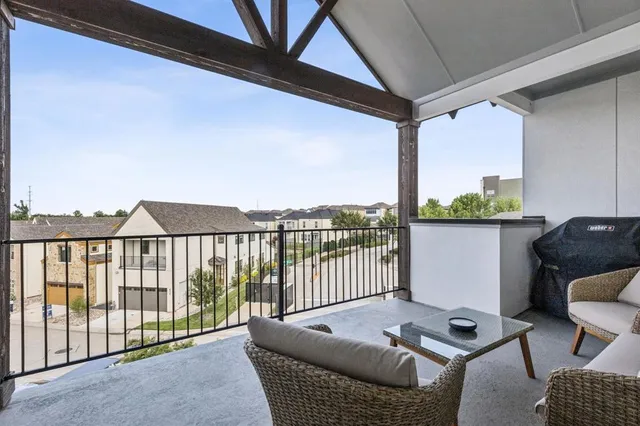 a balcony with furniture and wooden floor