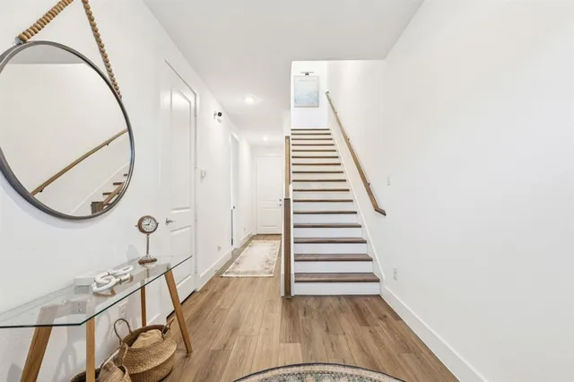 a view of a room with wooden floor and staircase
