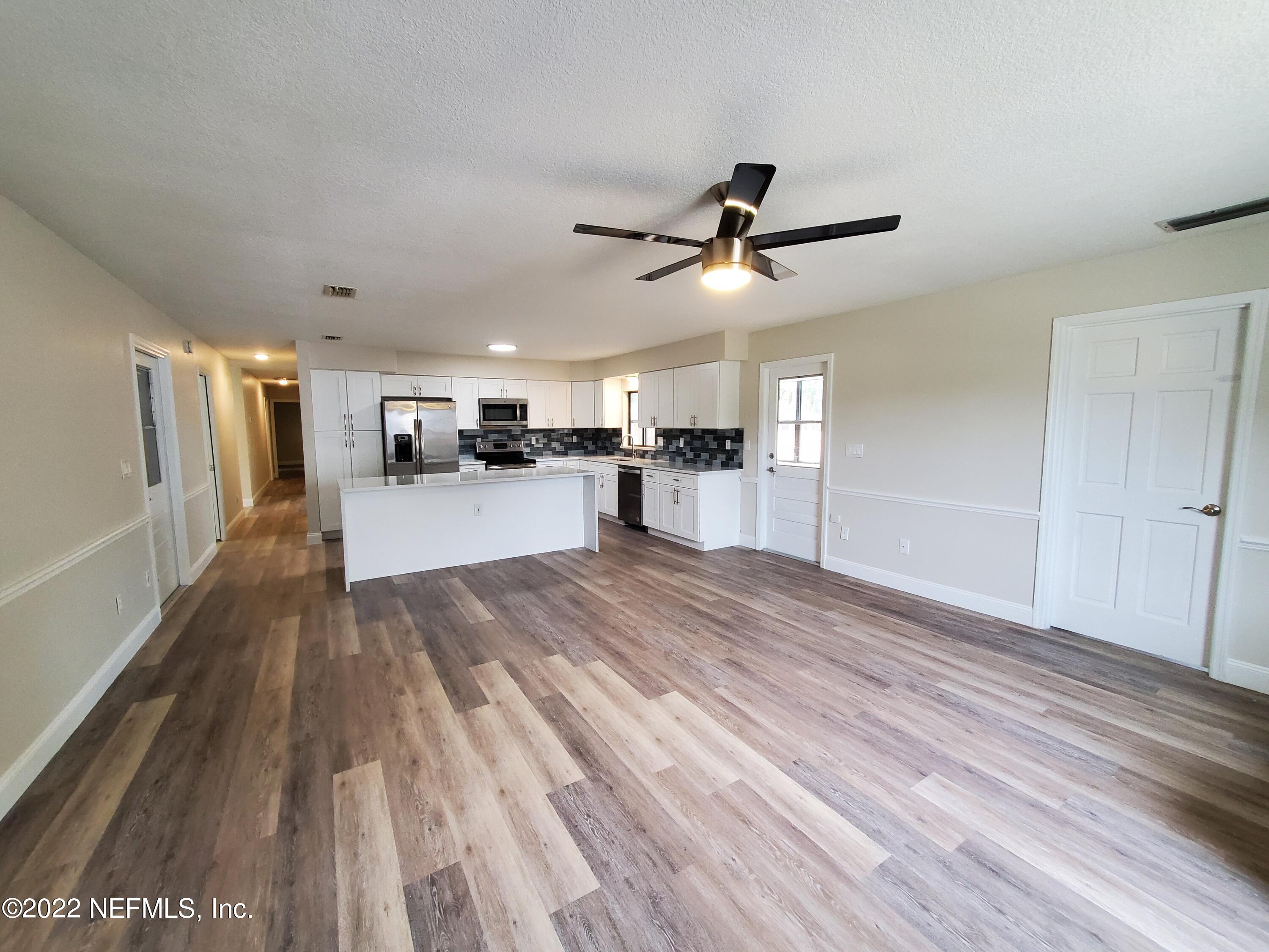 111 Nautilus Road St. Augustine, FL 32086 - Photo 12 of 35 a view of a living room hardwood floor and a ceiling fan