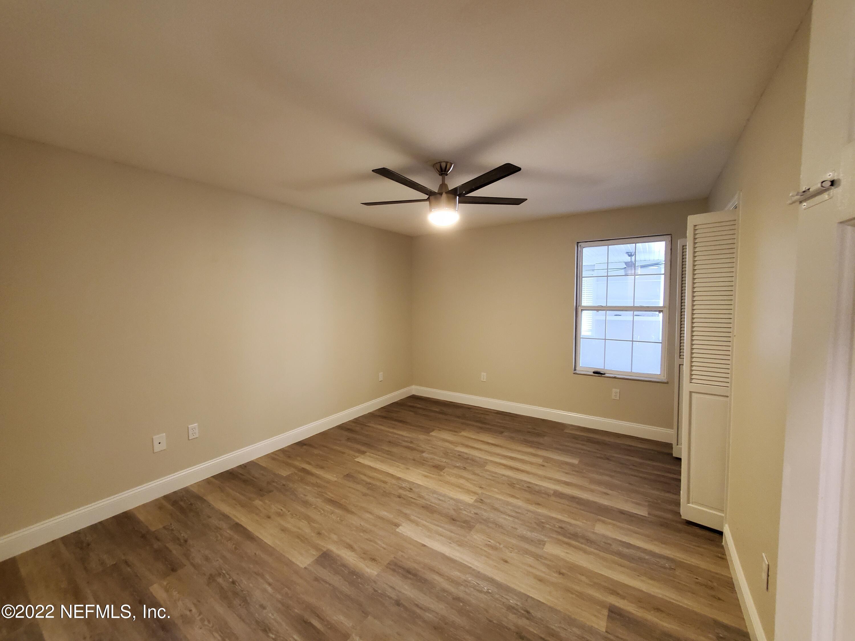 111 Nautilus Road St. Augustine, FL 32086 - Photo 17 of 35 wooden floor in an empty room and a window