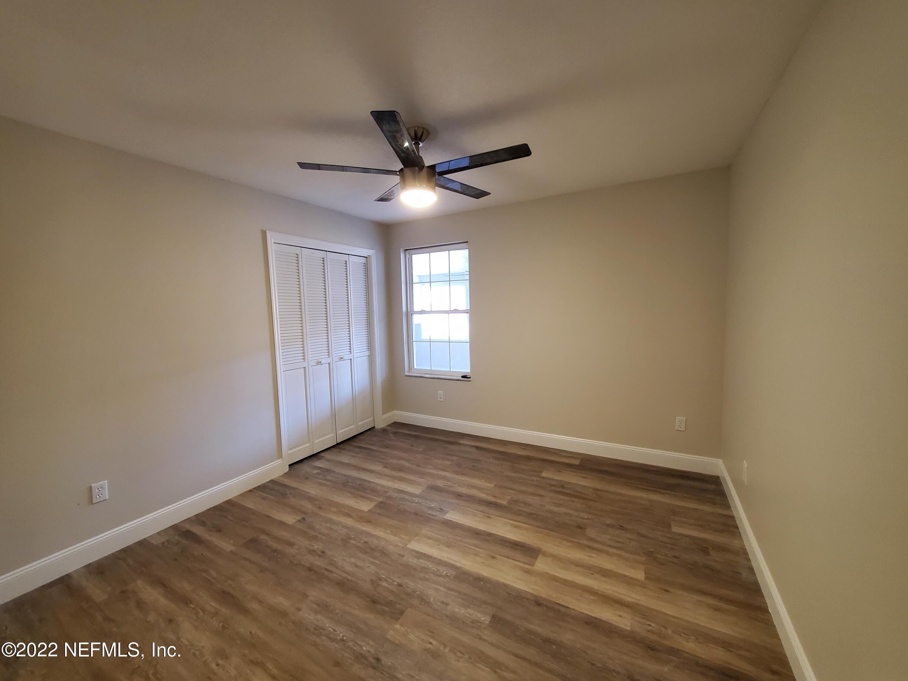 111 Nautilus Road St. Augustine, FL 32086 - Photo 19 of 35 wooden floor in an empty room with a window