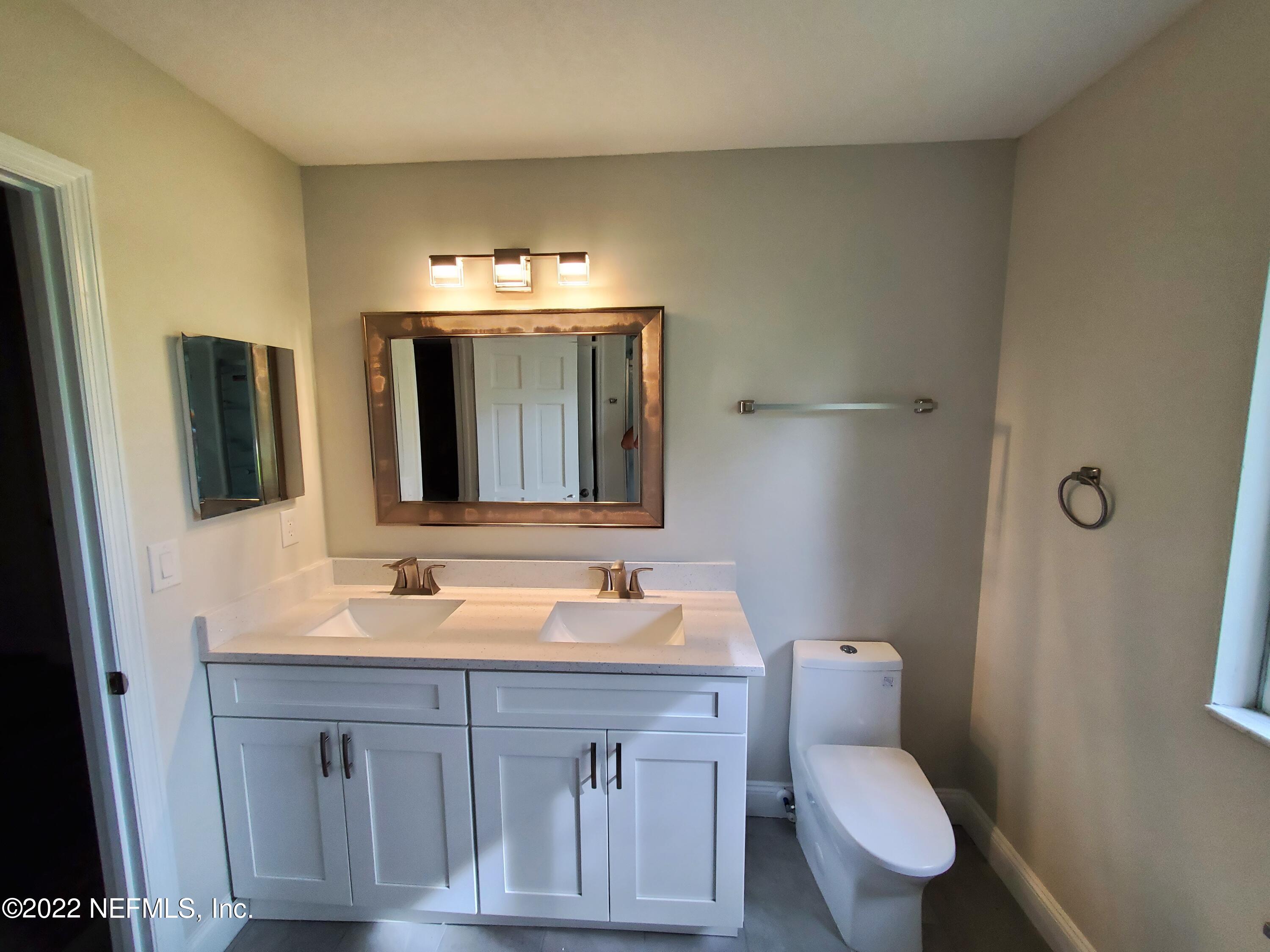 111 Nautilus Road St. Augustine, FL 32086 - Photo 23 of 35 a bathroom with a toilet sink and mirror