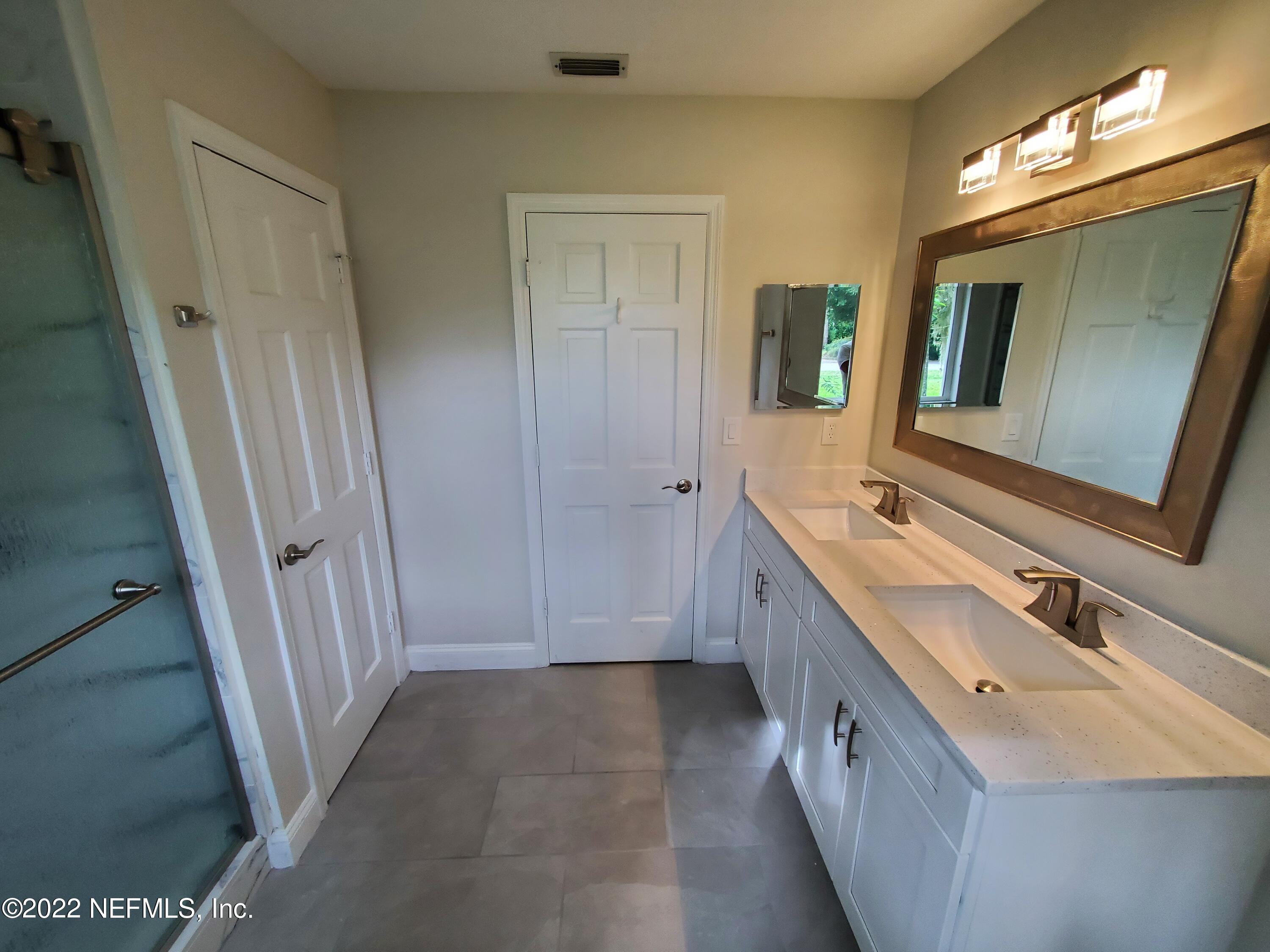 111 Nautilus Road St. Augustine, FL 32086 - Photo 24 of 35 a bathroom with a double vanity sink and mirror