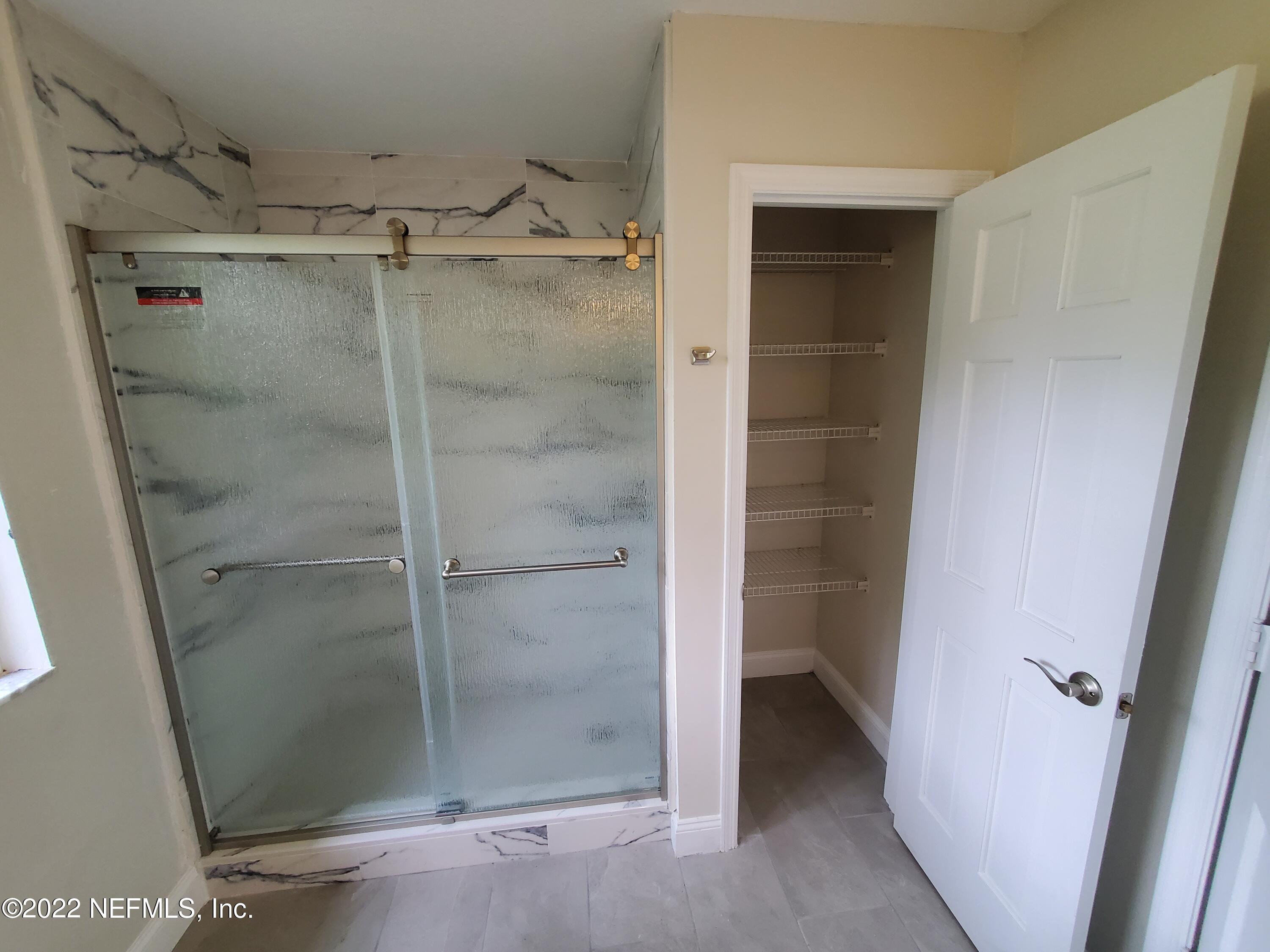 111 Nautilus Road St. Augustine, FL 32086 - Photo 25 of 35 a bathroom with a glass door shower