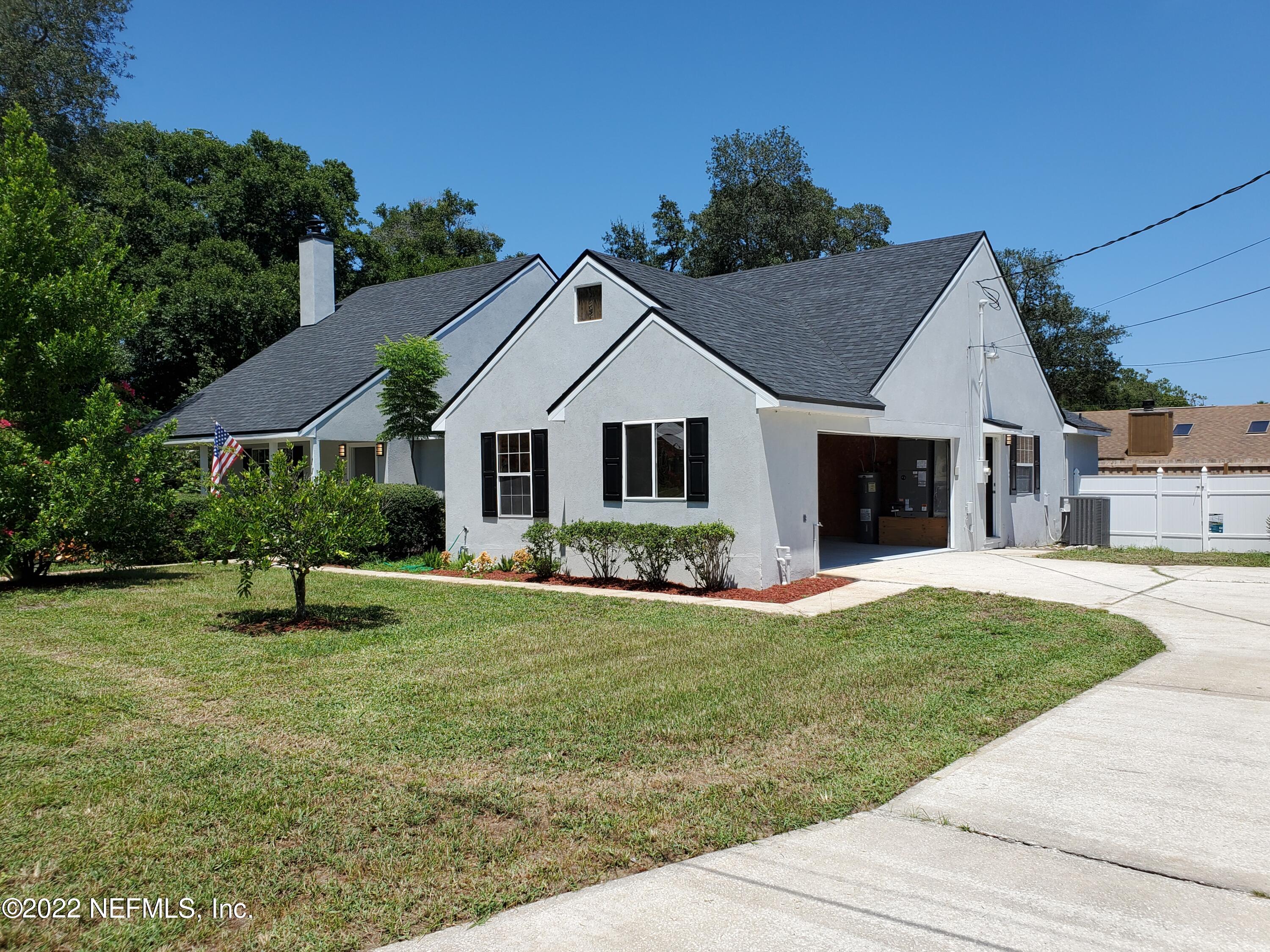 111 Nautilus Road St. Augustine, FL 32086 - Photo 3 of 35 a front view of a house with a garden and trees