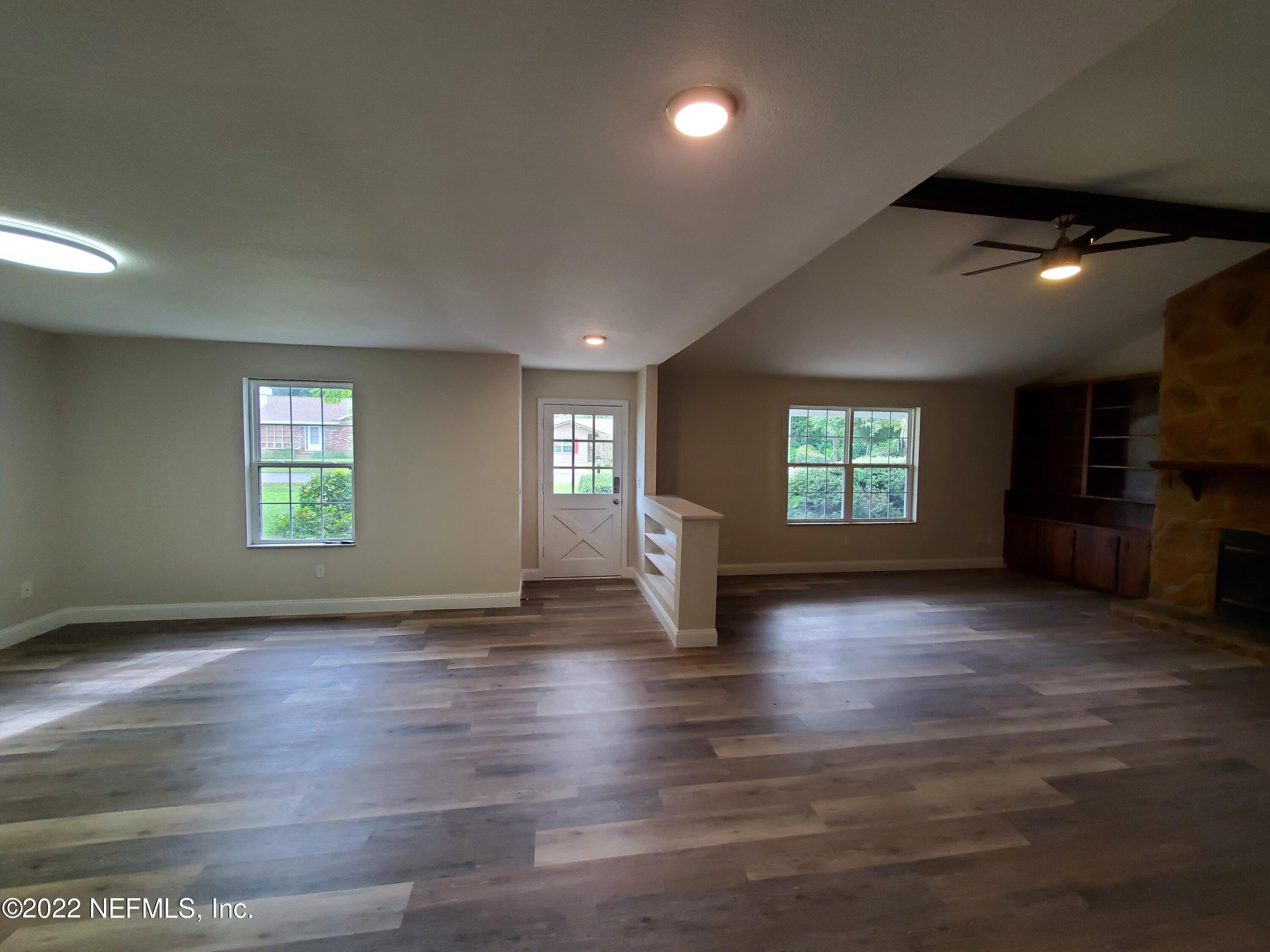 111 Nautilus Road St. Augustine, FL 32086 - Photo 7 of 35 an empty room with wooden floor and windows