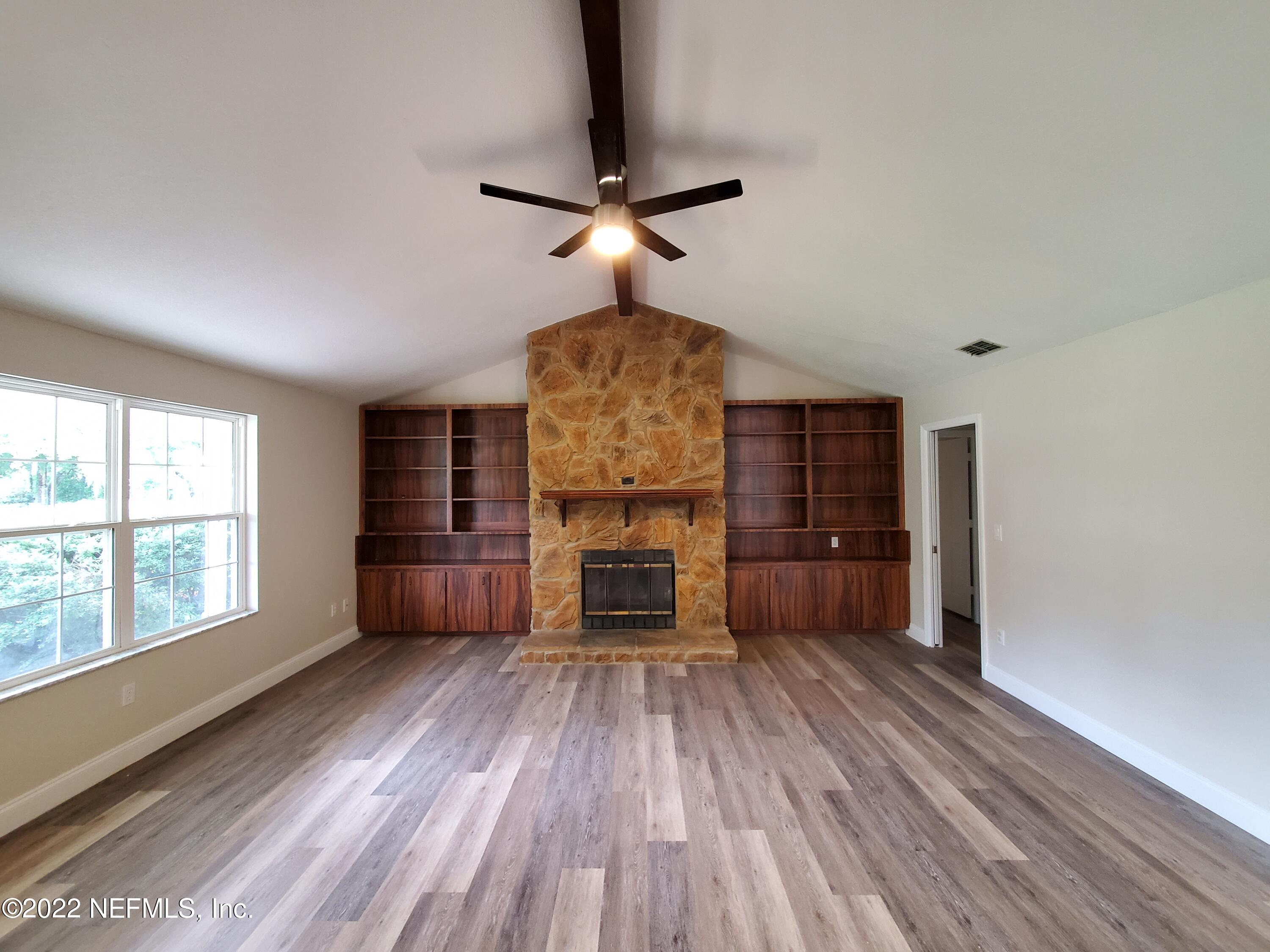 111 Nautilus Road St. Augustine, FL 32086 - Photo 8 of 35 a living room with furniture and a fireplace