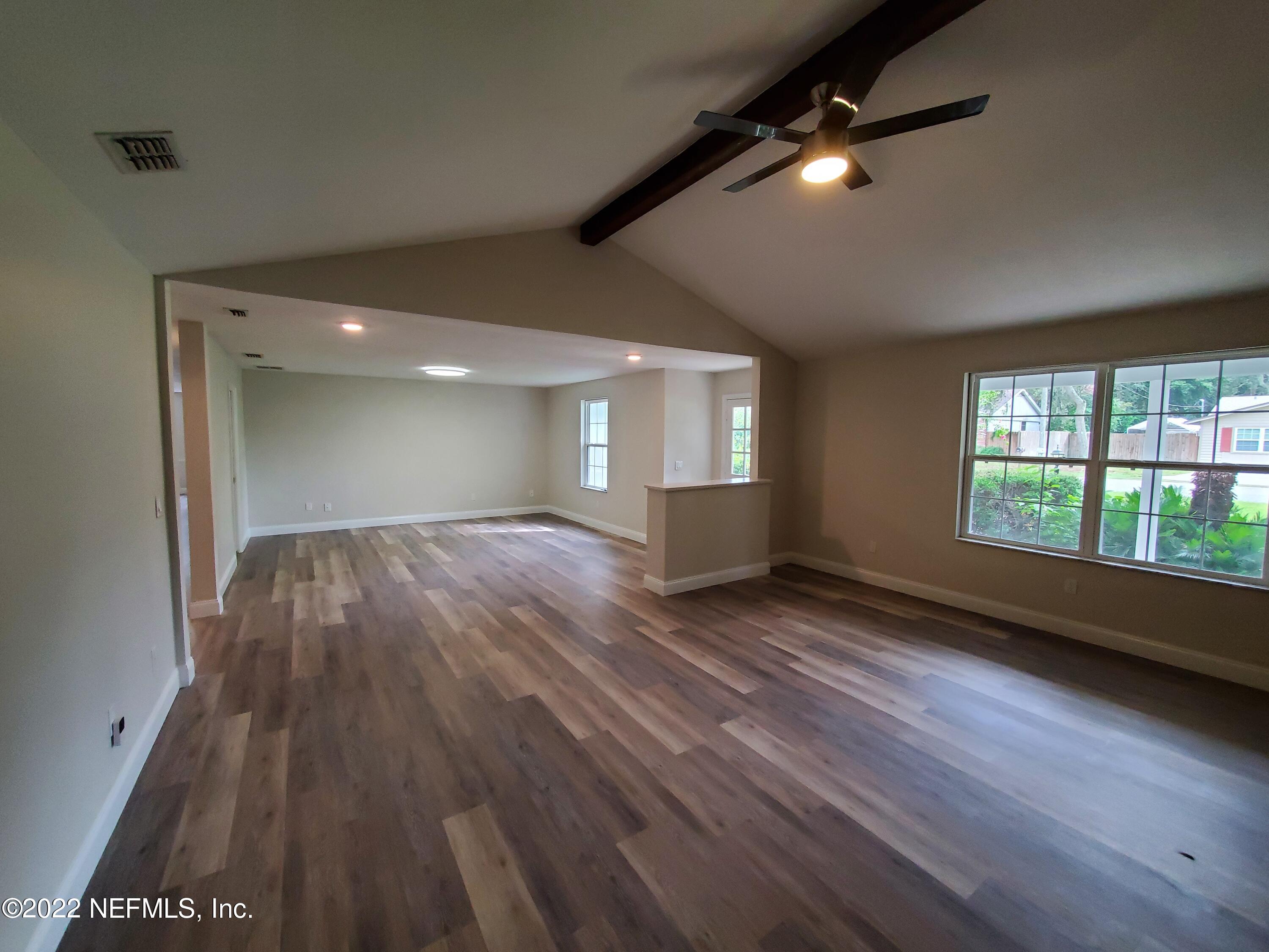 111 Nautilus Road St. Augustine, FL 32086 - Photo 9 of 35 a view of an empty room with wooden floor and a window