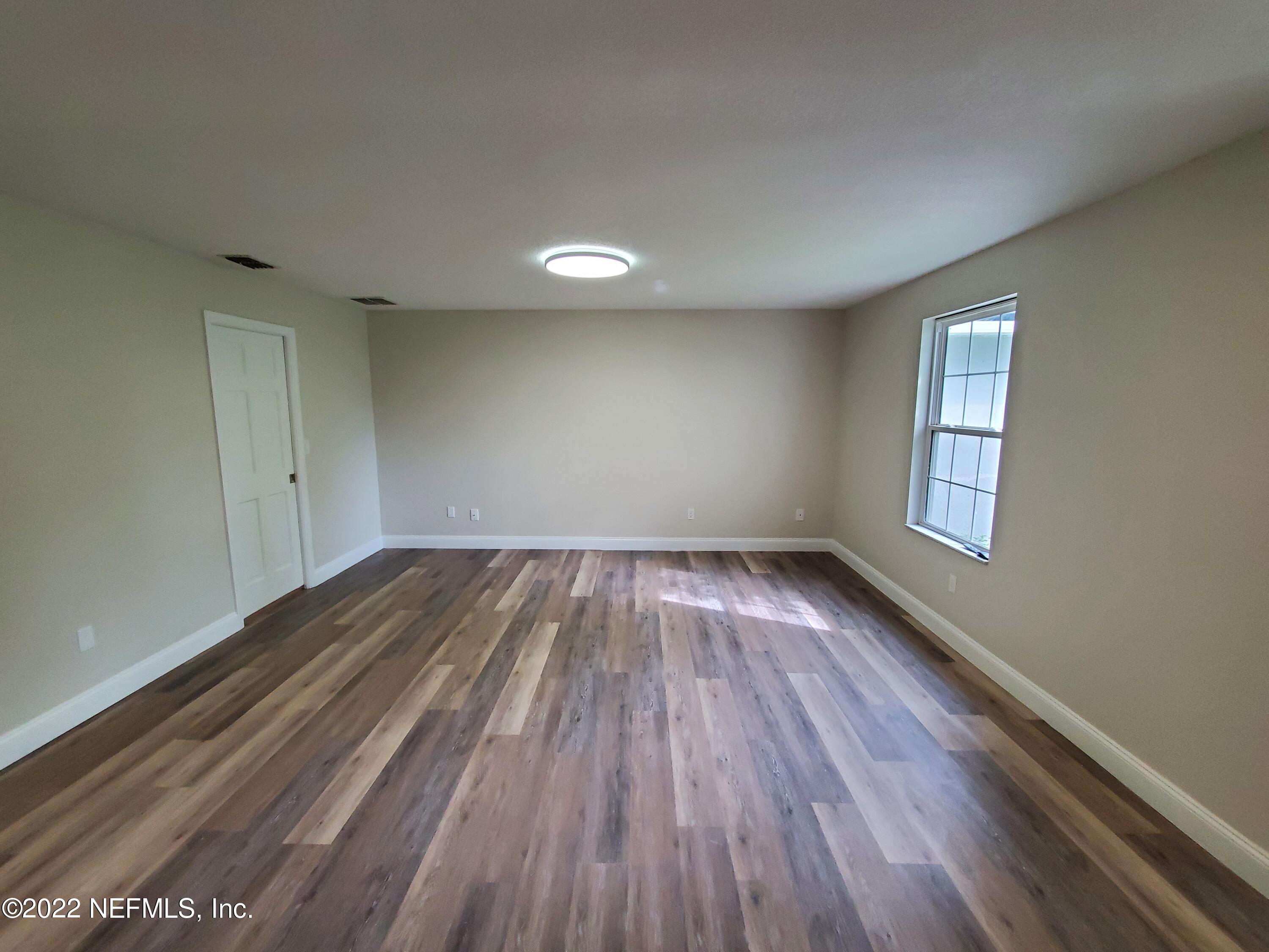 111 Nautilus Road St. Augustine, FL 32086 - Photo 10 of 35 wooden floor in an empty room with a window