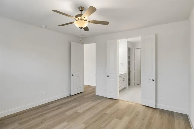 a bathroom with a tub a sink and mirrors