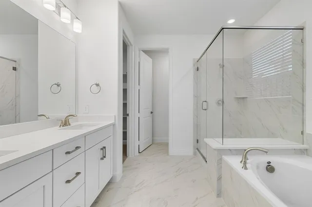 a spacious bathroom with a double vanity sink mirror double and shower