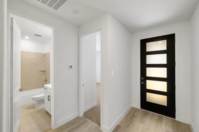a view of a hallway with wooden floor