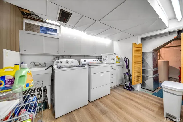 a utility room with fridge dryer and washer