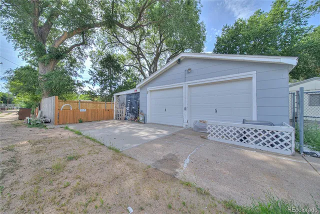 a view of a house with a yard and garage