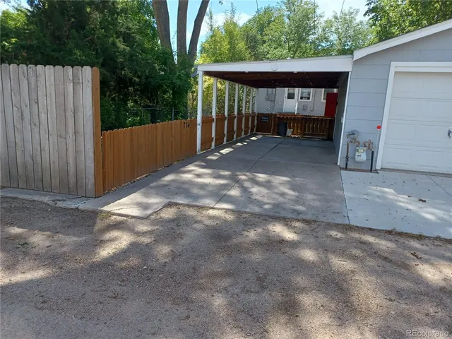 a view of a house with a backyard and a garage