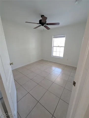a view of an empty room and a window