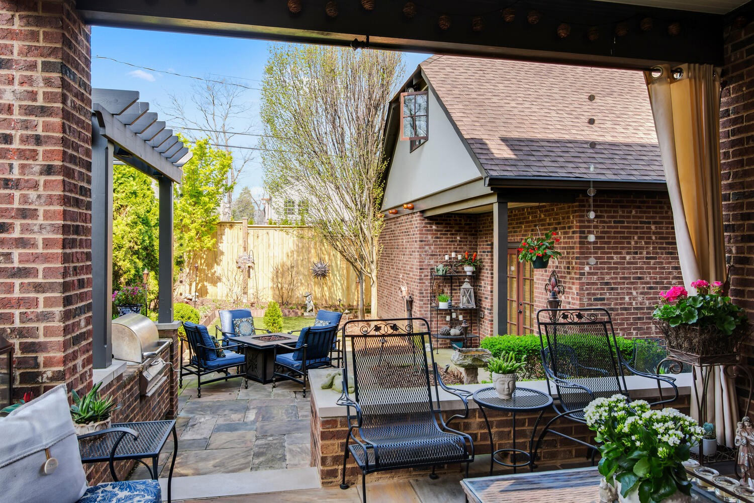 4018 Valley Road Nashville, TN 37205 - Photo 4 of 39 a view of a patio with table and chairs potted plants and a large tree