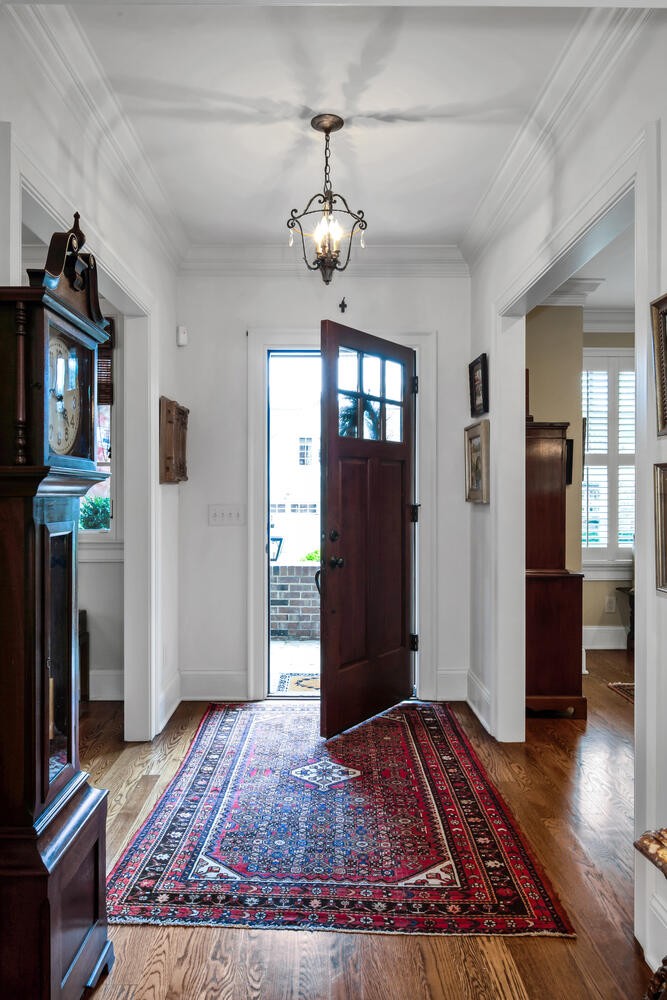 4018 Valley Road Nashville, TN 37205 - Photo 7 of 39 a view of a hallway with wooden floor and a chandelier