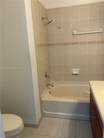 a bathroom with a bathtub and a toilet