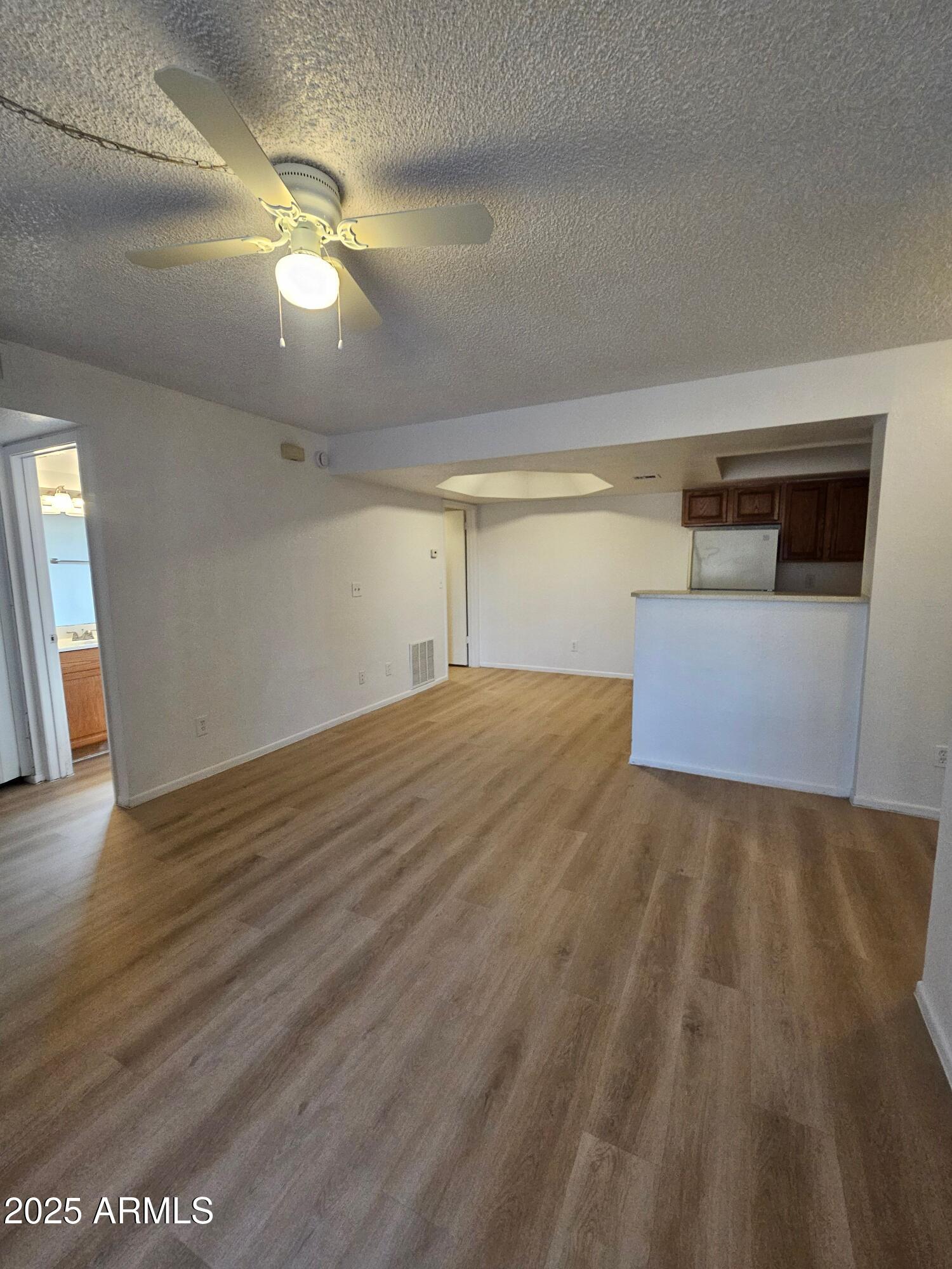 1370 South Price Road, Unit 101 Tempe, AZ 85281 - Photo 1 of 11 a view of empty room with wooden floor