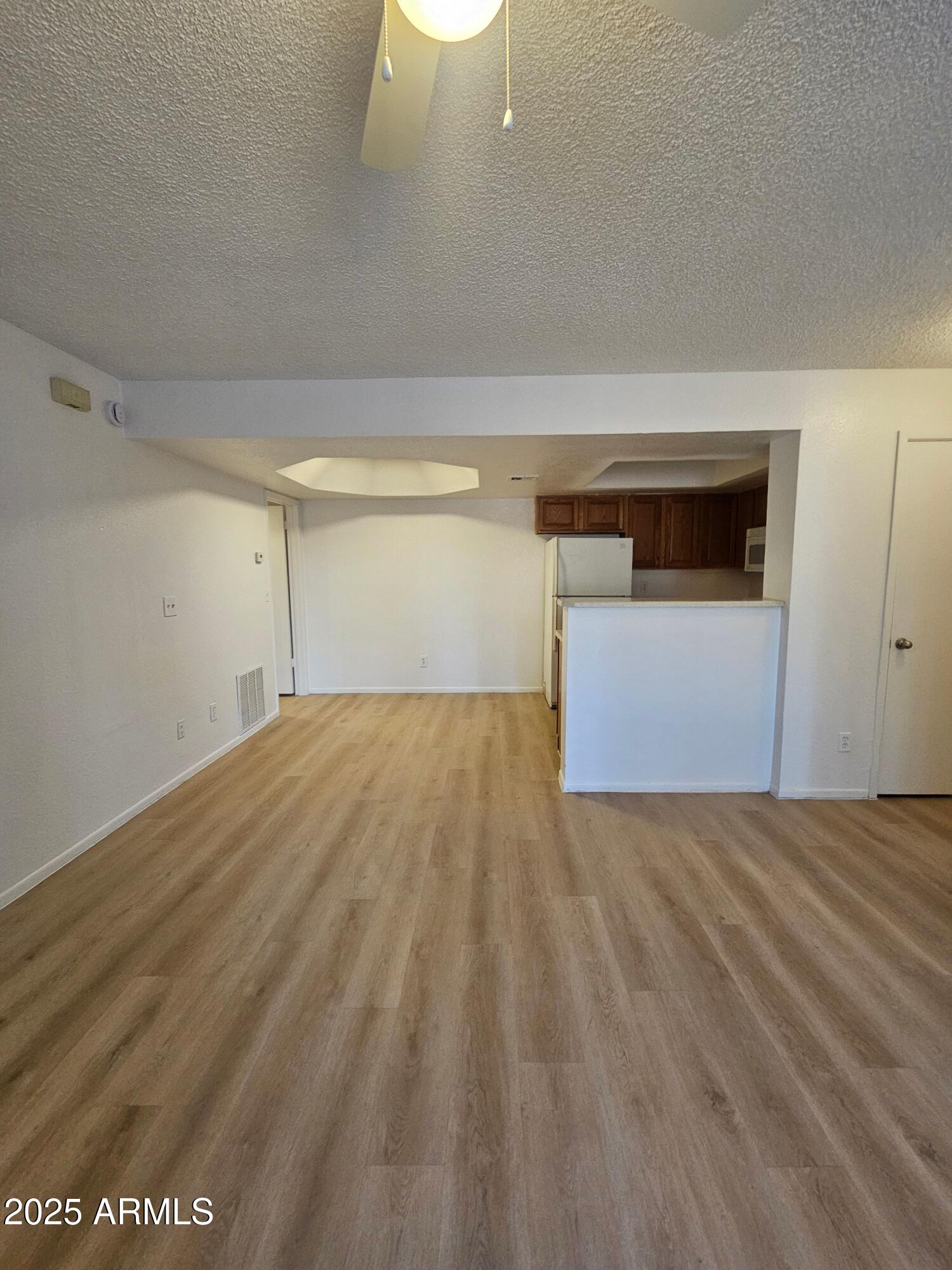 1370 South Price Road, Unit 101 Tempe, AZ 85281 - Photo 2 of 11 a view of empty room with wooden floor