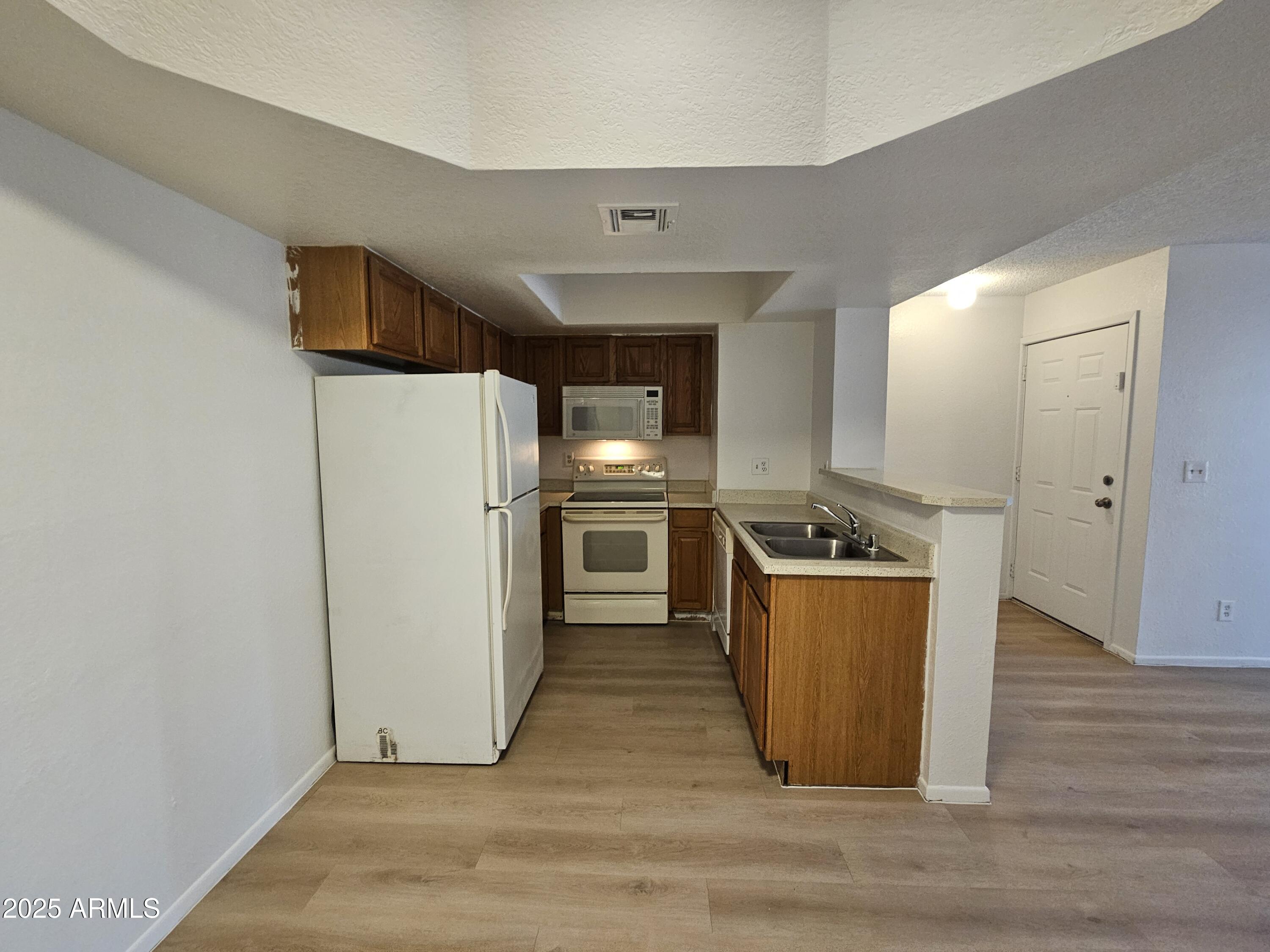1370 South Price Road, Unit 101 Tempe, AZ 85281 - Photo 4 of 11 a kitchen with stainless steel appliances a refrigerator and a stove