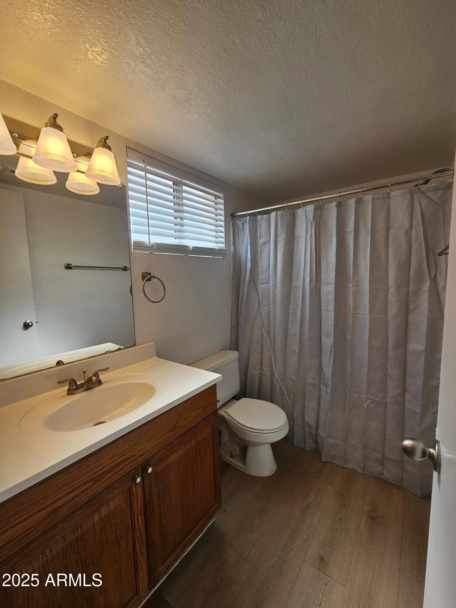 1370 South Price Road, Unit 101 Tempe, AZ 85281 - Photo 8 of 11 a bathroom with a sink and a mirror