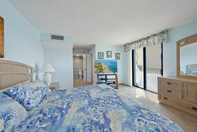 a bedroom with a bed and a dresser in it