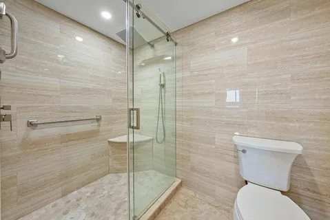 a bathroom with a toilet and a shower