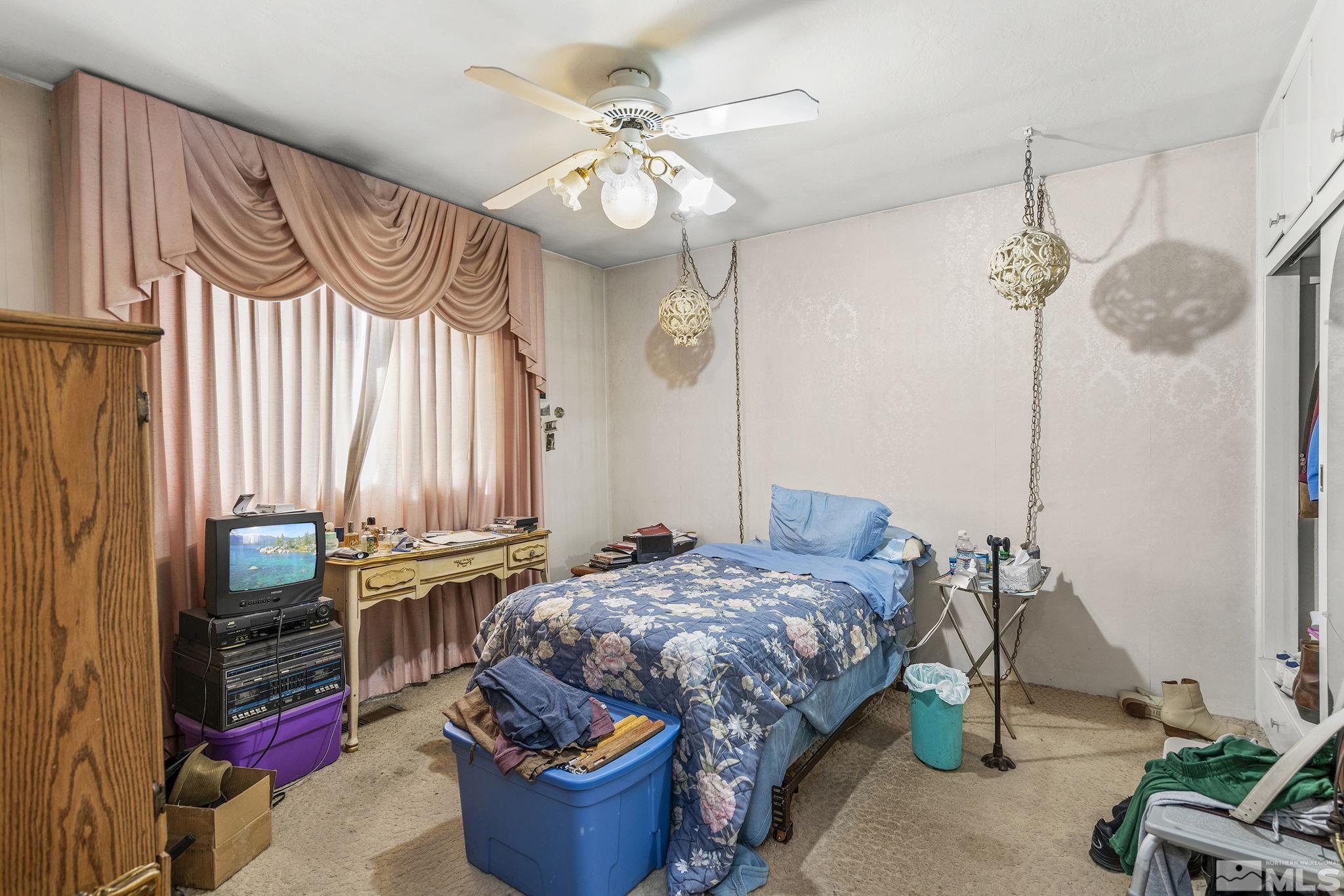 655 Belgrave Avenue Reno, NV 89502 - Photo 9 of 17 a bedroom with bed and a chandelier