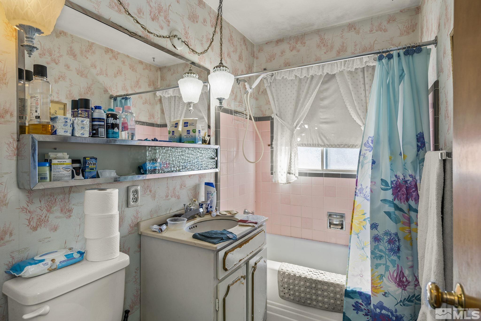 655 Belgrave Avenue Reno, NV 89502 - Photo 10 of 17 a bathroom with a sink a bath tub and a shower curtain