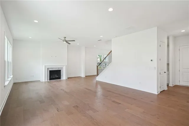 an empty room with wooden floor and fireplace