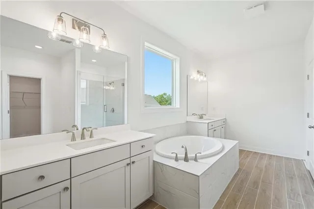 a bathroom with a tub sink and mirror