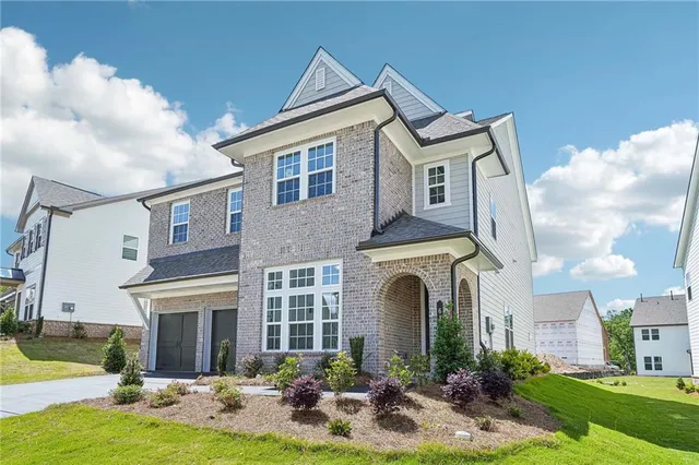 a front view of a house with yard and porch