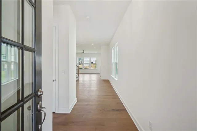 a view of a hallway with wooden floor