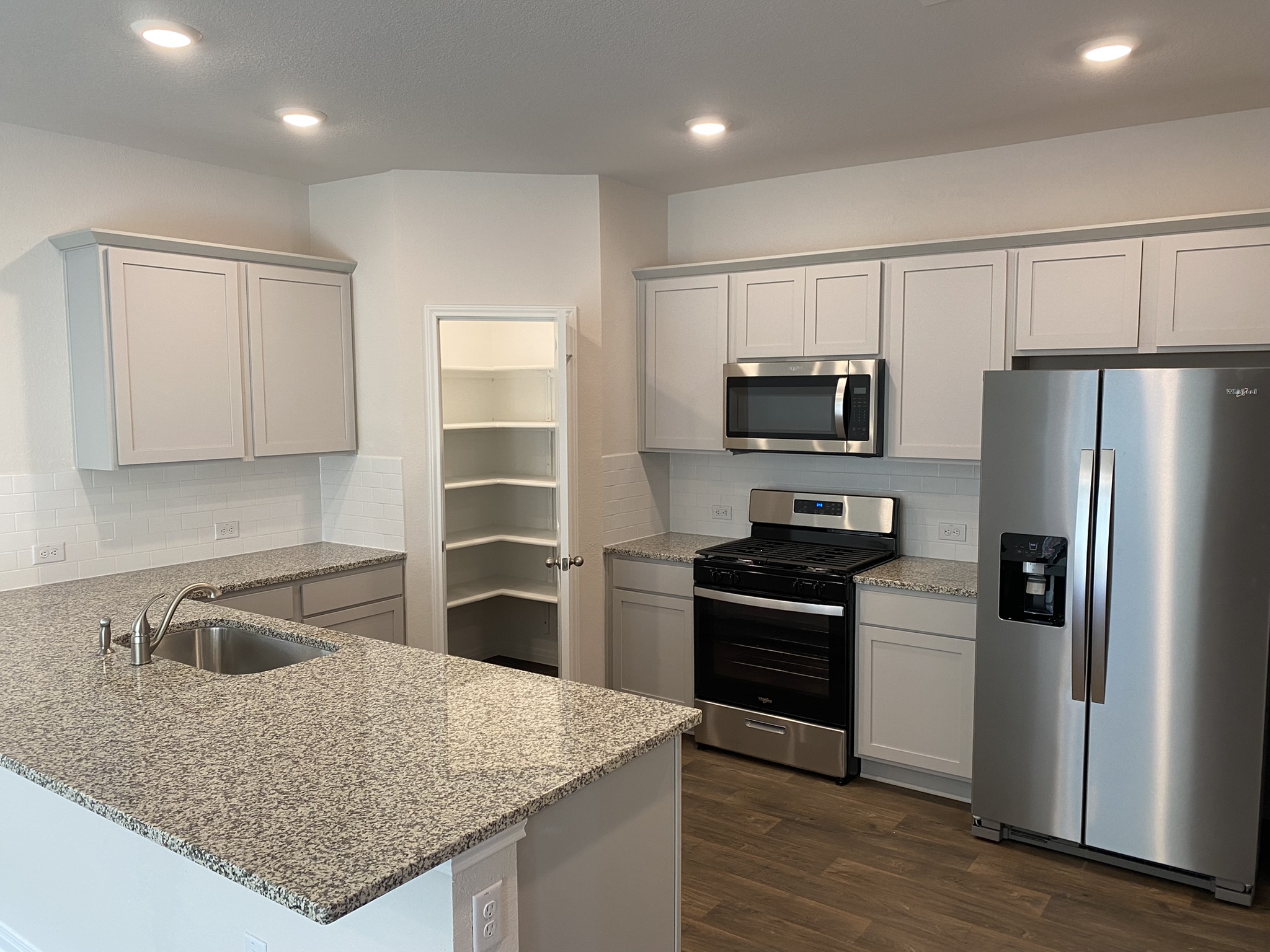 236 Sunniberg Loop Georgetown, TX 78626 - Photo 5 of 22 Polished granite countertops complement sleek cabinetry and modern stainless steel appliances in this functional layout.