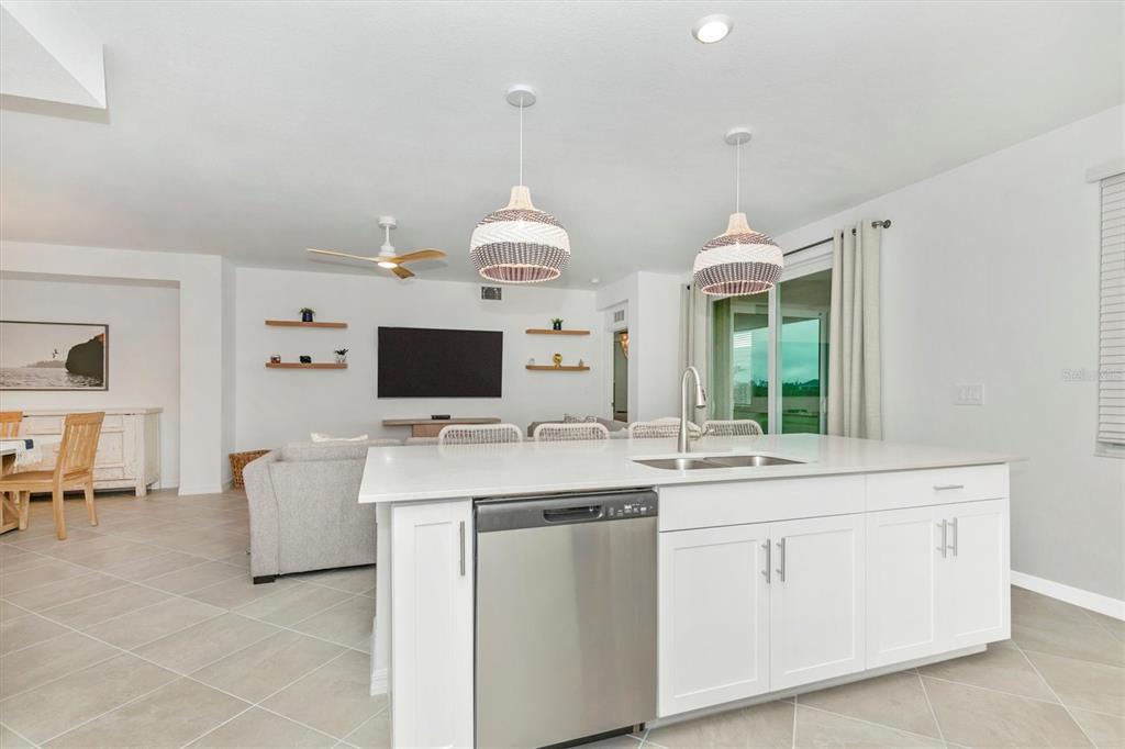 12625 Radiance Court, Unit 102 Venice, FL 34293 - Photo 16 of 99 a living room with furniture and a flat screen tv