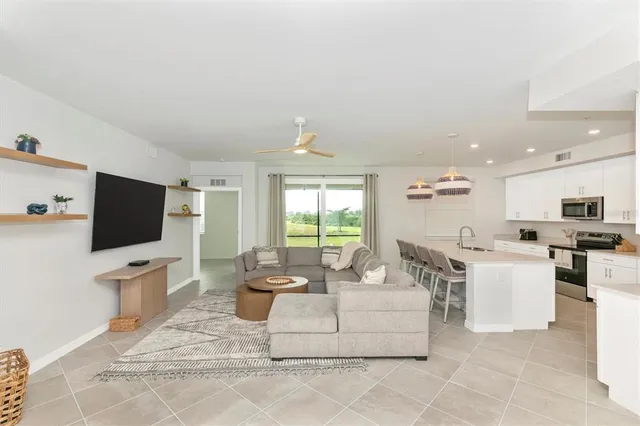 a spacious bedroom with a bed and a flat screen tv