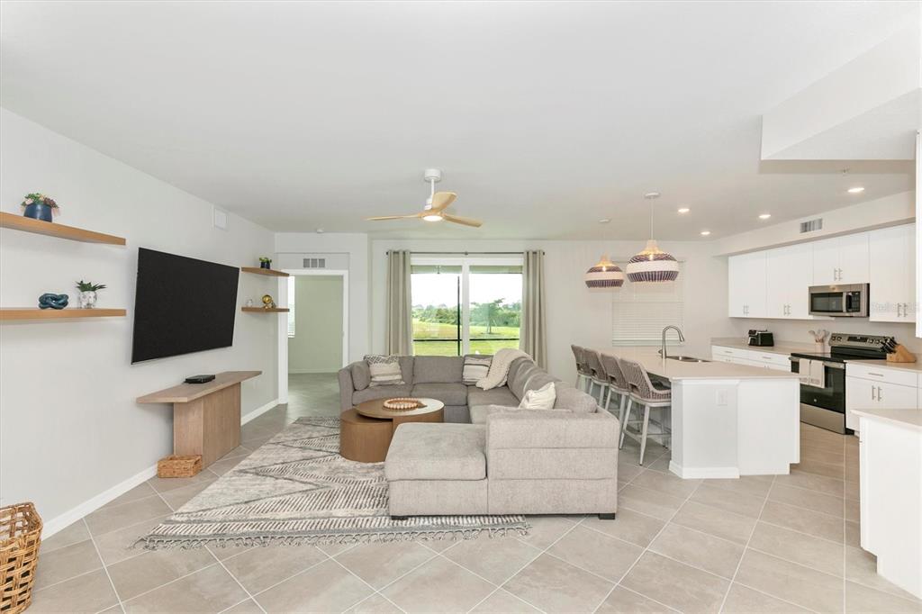 12625 Radiance Court, Unit 102 Venice, FL 34293 - Photo 17 of 99 a living room with fireplace furniture and a flat screen tv