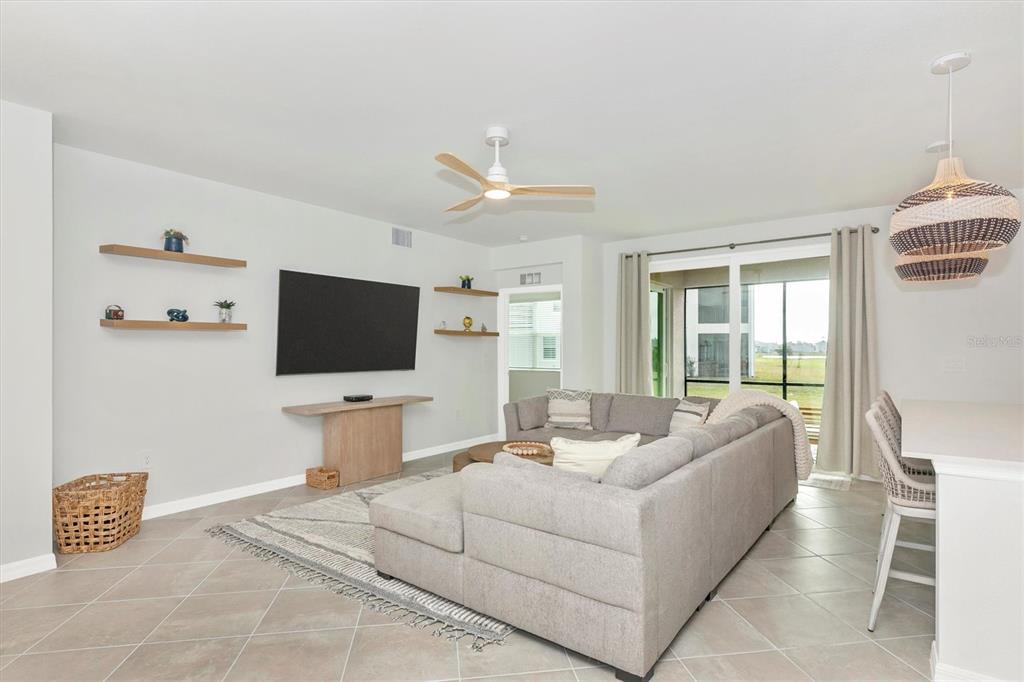 12625 Radiance Court, Unit 102 Venice, FL 34293 - Photo 18 of 99 a living room with furniture and a flat screen tv