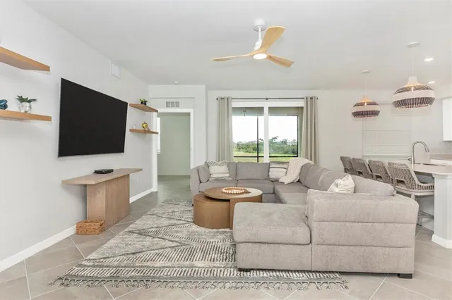a bedroom with a bed and a flat tv screen on dresser