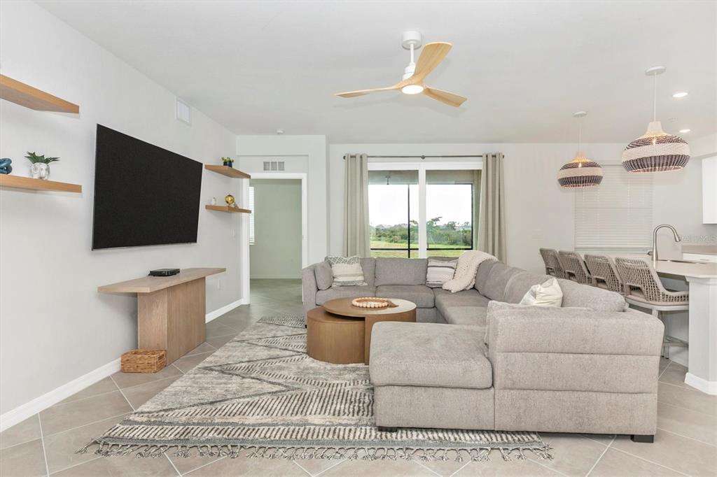 12625 Radiance Court, Unit 102 Venice, FL 34293 - Photo 19 of 99 a living room with furniture and a flat screen tv