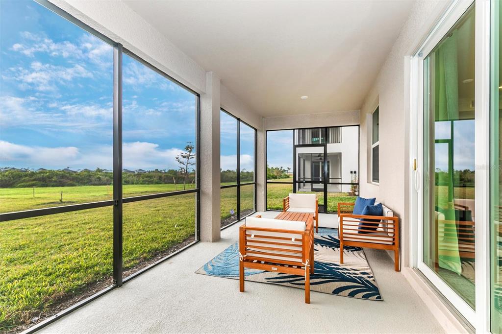 12625 Radiance Court, Unit 102 Venice, FL 34293 - Photo 27 of 99 a backyard of a house with outdoor seating