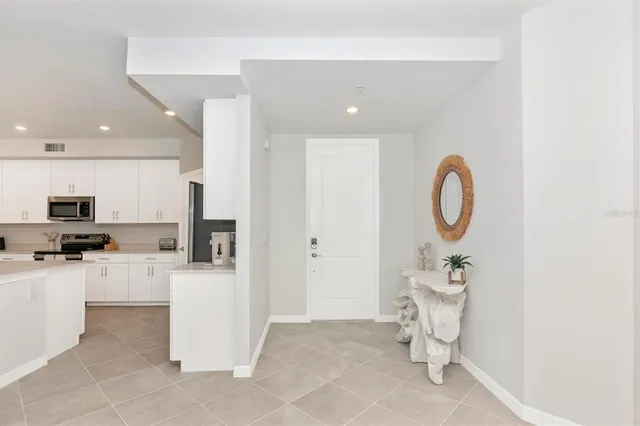 a living room with furniture a mirror and a dining table