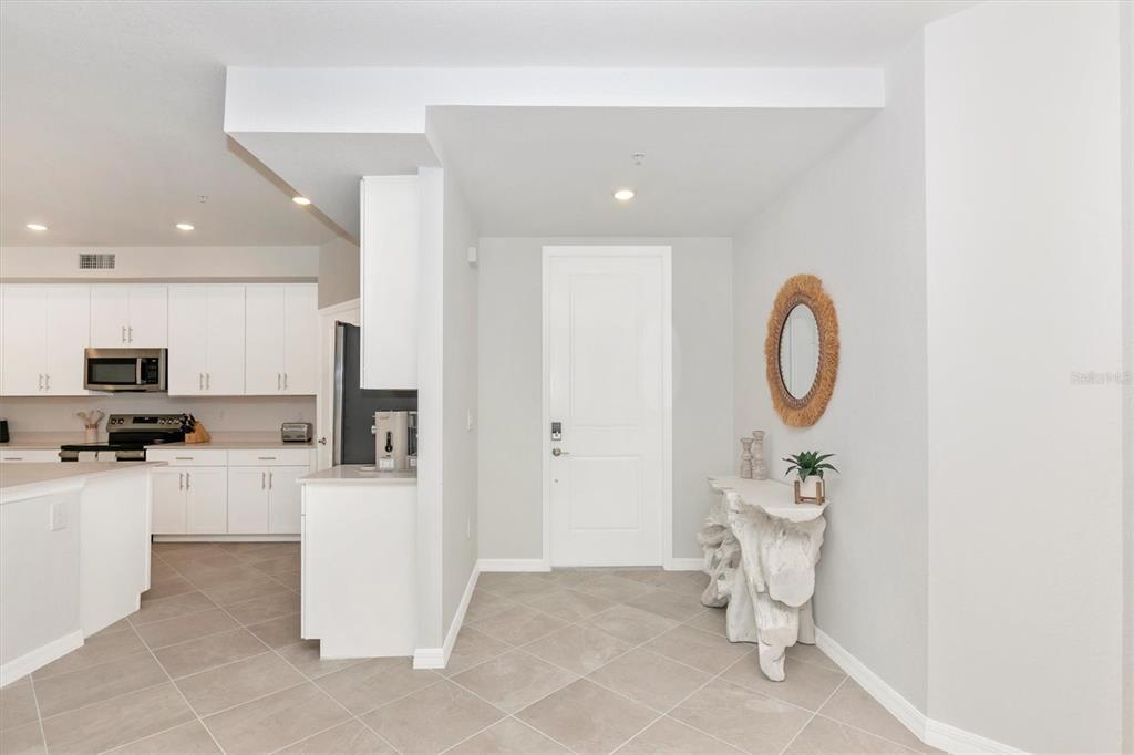 12625 Radiance Court, Unit 102 Venice, FL 34293 - Photo 3 of 99 a living room with furniture a sink and a fireplace