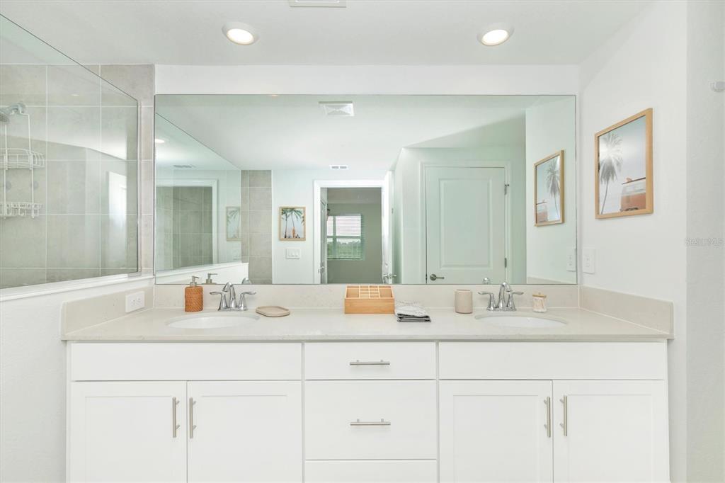 12625 Radiance Court, Unit 102 Venice, FL 34293 - Photo 36 of 99 a bathroom with a sink vanity and mirror