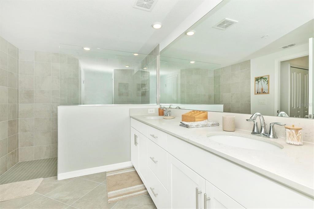 12625 Radiance Court, Unit 102 Venice, FL 34293 - Photo 37 of 99 a bathroom with a double vanity sink mirror and