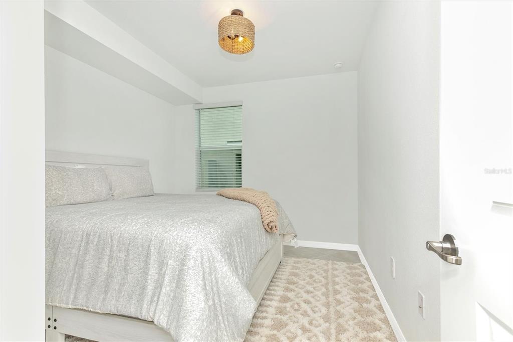 12625 Radiance Court, Unit 102 Venice, FL 34293 - Photo 39 of 99 a bedroom with a bed and a window